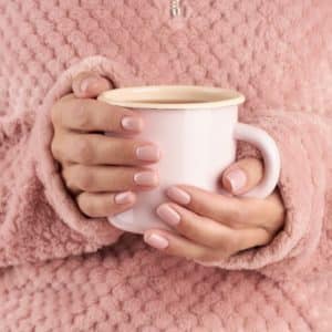 hands holding cup of tea